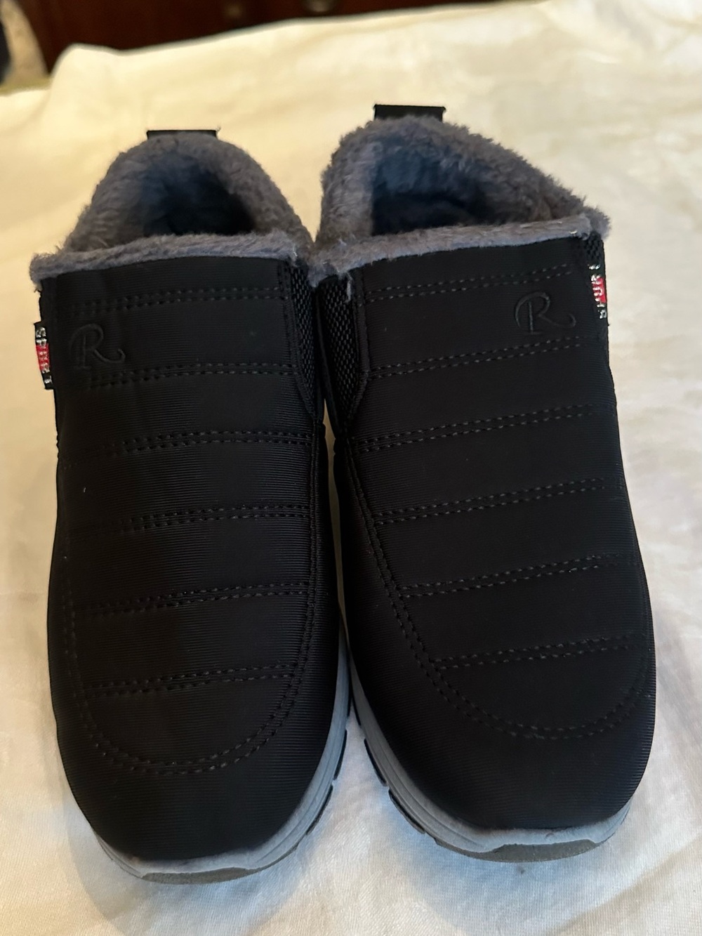 Fleece lined booties, black fabric outer…never worn 7m